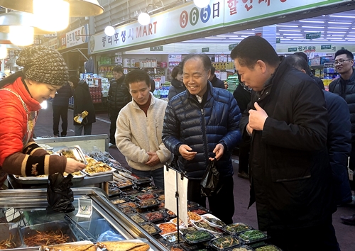 조봉환 소상공인시장진흥공단 이사장(오른쪽 두 번째)이 14일 대전중리전통시장에서 임직원들과 먹거리를 구입하고 있다. 사진=소진공 제공