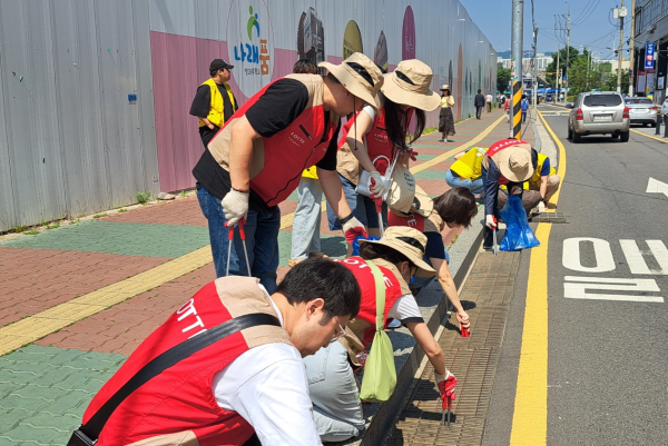 지난 16일 한국후지필름(주) 직원들과 자원봉사자들이 빗물받이 정화 활동을 하고 있다. 사진=금천구 제공